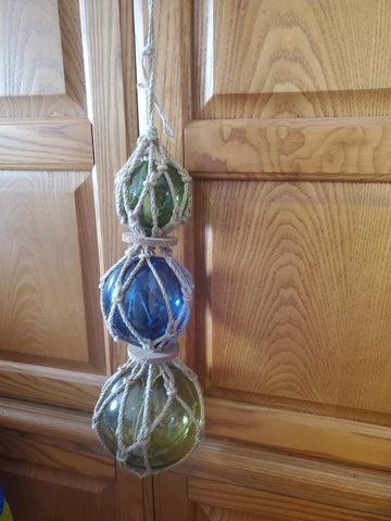 STRAND OF 3 NAUTICAL GLASS FLOATS 23" LONG, LARGEST FLOAT 5" DIAMETER